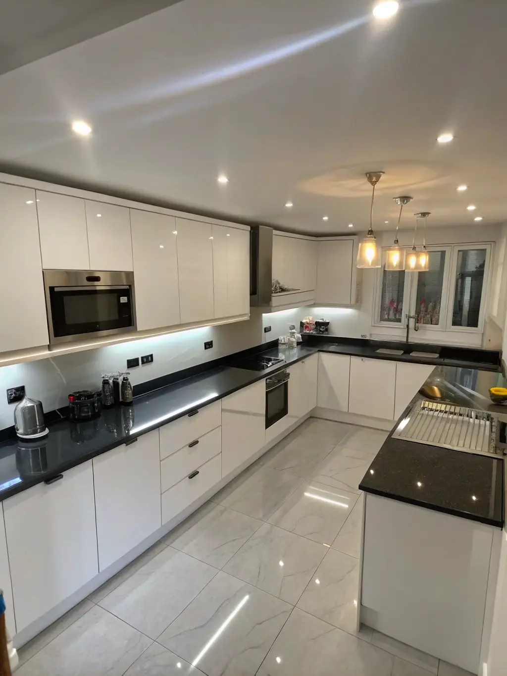 A sleek kitchen with modern cabinetry showcasing a variety of wood finishes and hardware, highlighting DEON1 INC's wholesale cabinetry service.